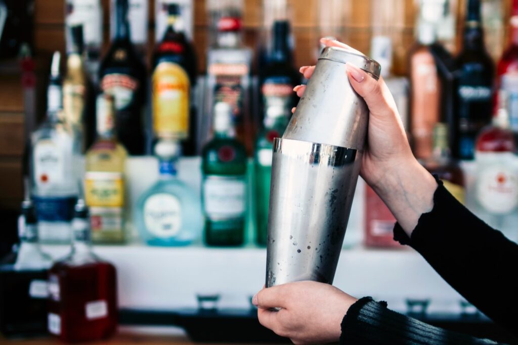 mani-del-barista-ritagliare-la-preparazione-di-bevande-in-shaker